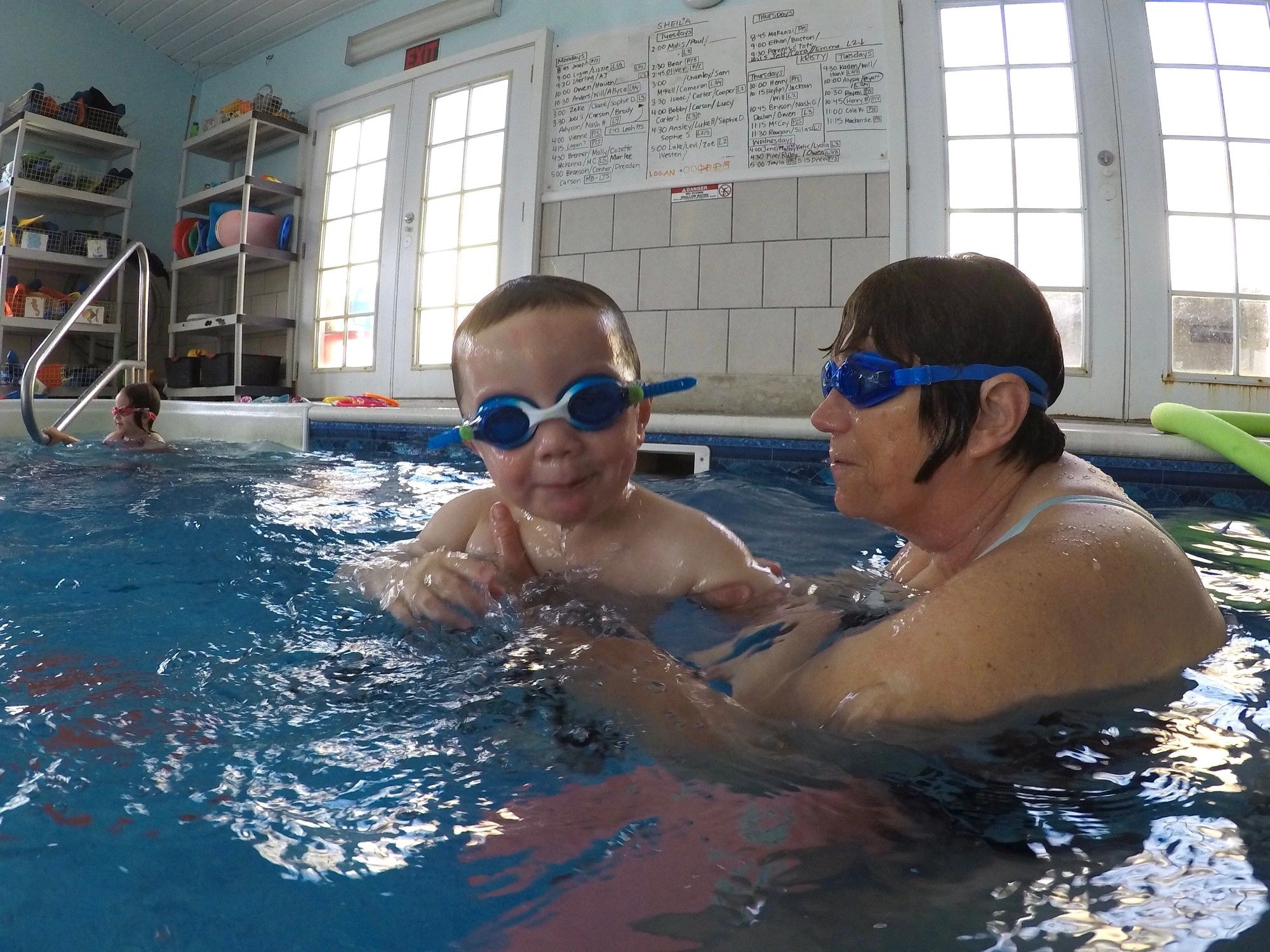 Instructor teaching a child to swim at The Swimmin' Hole